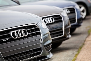 Front view of multiple Audi cars lined up showing distinctive grille and logo.