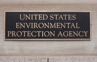 Signboard displaying the name of the United States Environmental Protection Agency on a building wall.