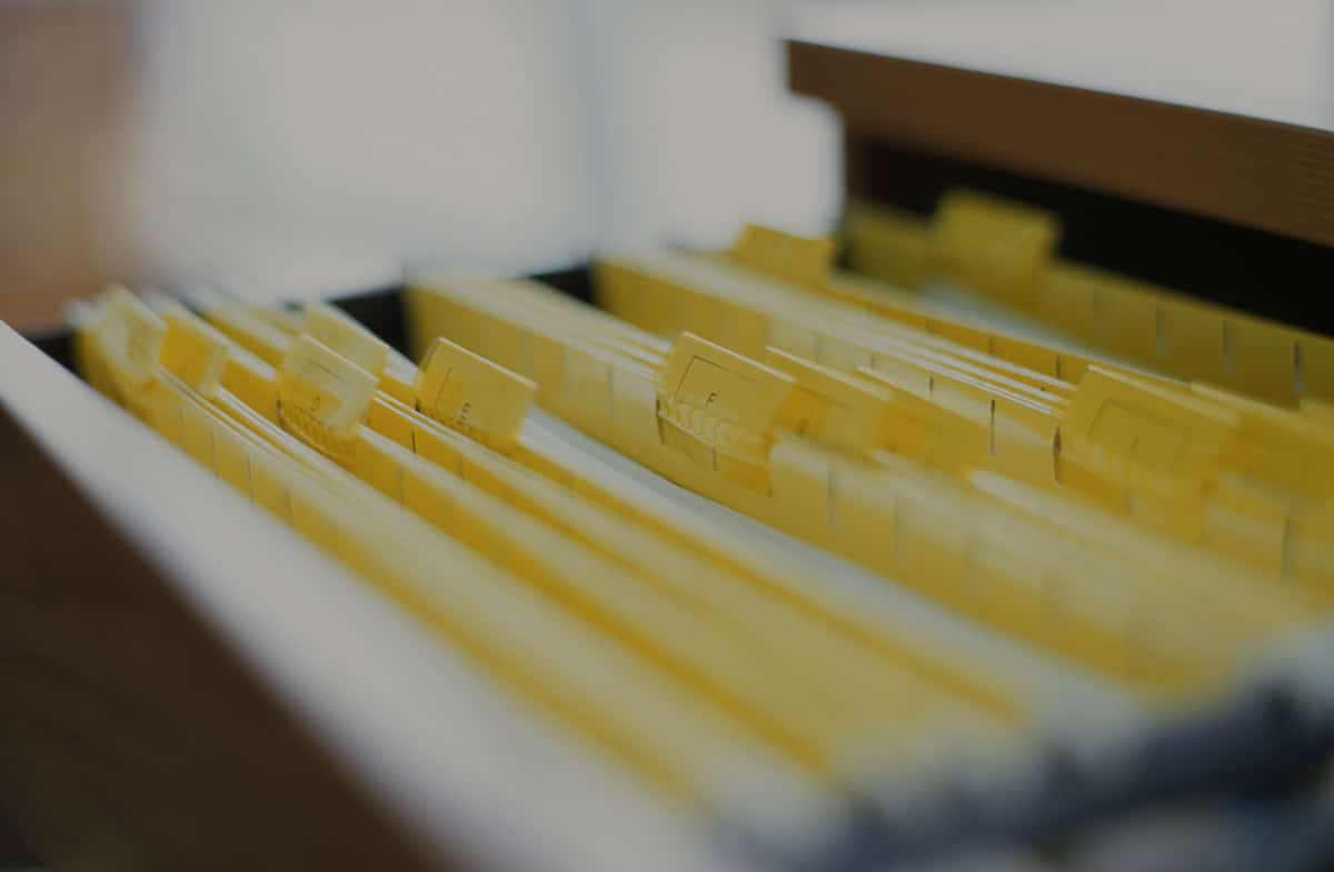 A file drawer filled with neatly organized yellow folders, showcasing a vibrant and orderly workspace.