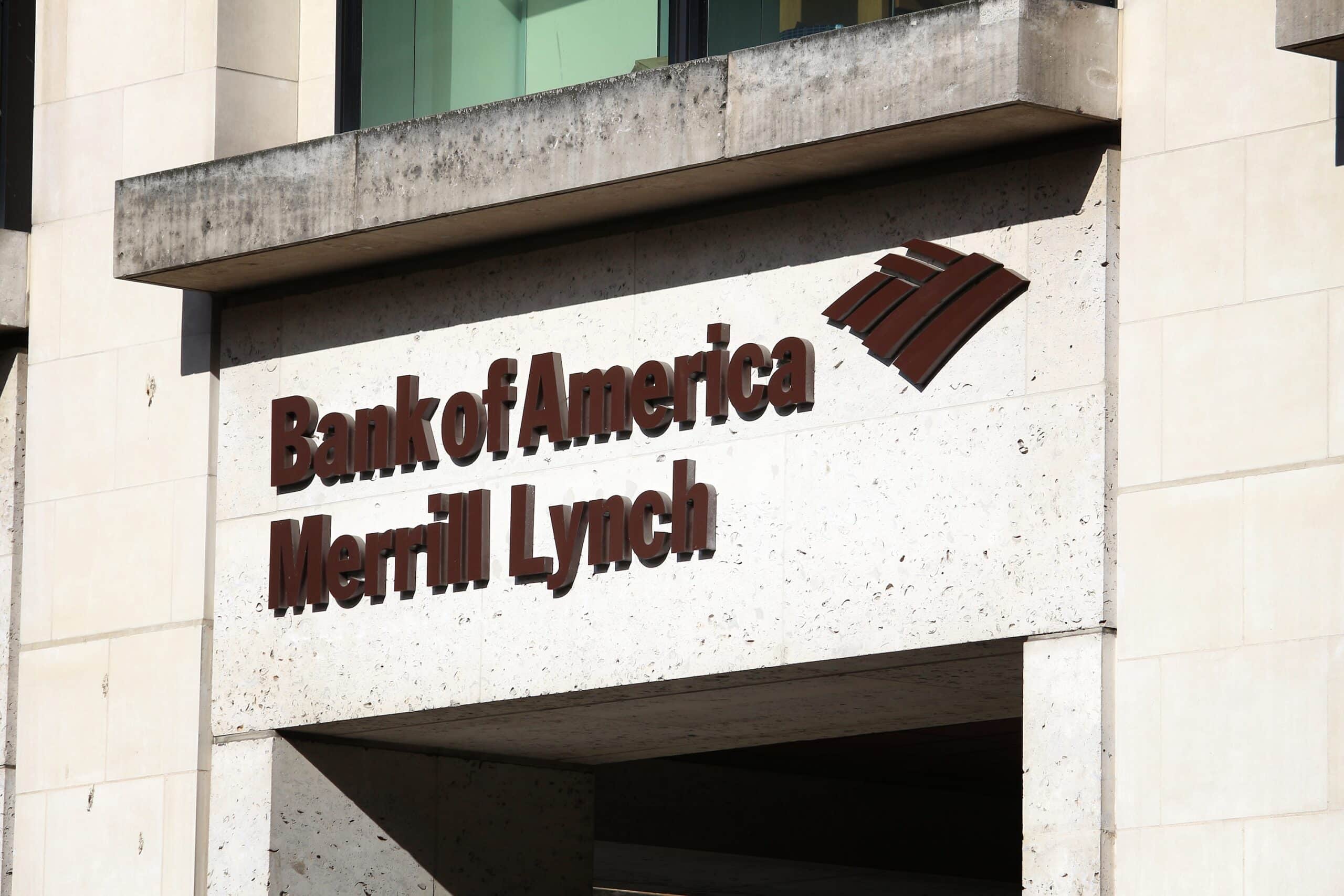 Sign displaying "Bank of America Merrill Lynch" on a beige stone building. The logo depicts a stylized flag. The tone is formal and professional.