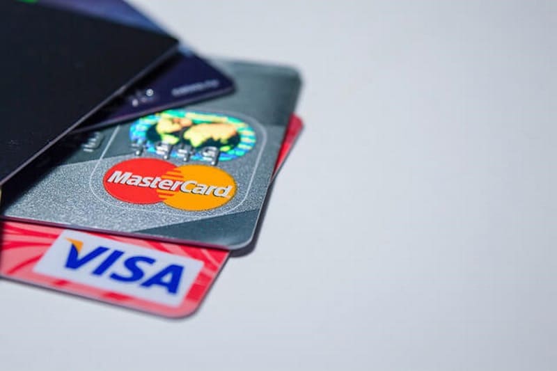 A stack of credit cards arranged neatly on top of one another, showcasing various colors and designs.