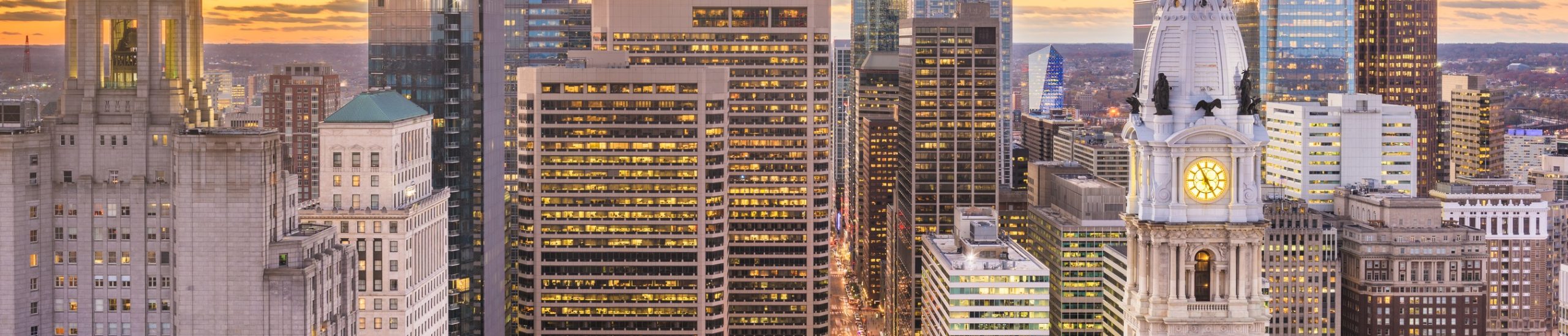 City skyline at dusk with warm lighting