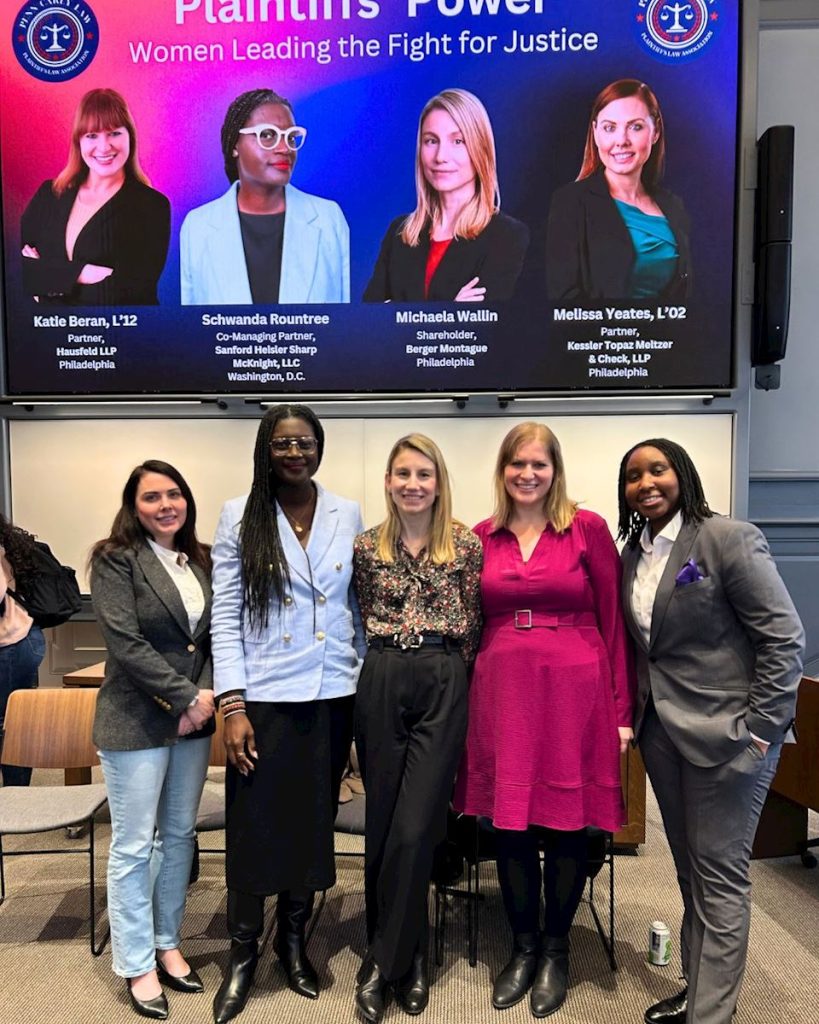 Group photo of five women standing together at an event.