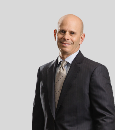 Stuart Berman Image Man in dark suit and tie, slight smile.