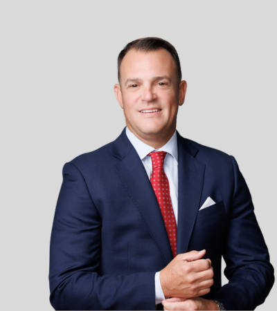 Jamie M. McCall Professional headshot of male attorney in navy suit and red tie.