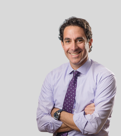 Lee D. Rudy Professional headshot of male attorney in lavender shirt and tie, arms crossed.
