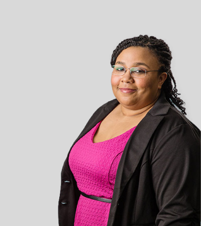 Melissa J. Starks: Studio portrait of a woman in pink top and dark blazer