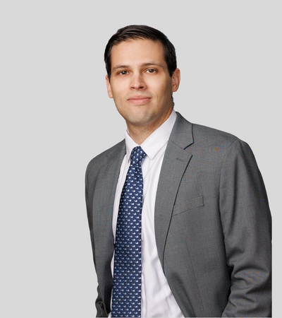 Kevin M. Kennedy: Studio portrait of a man in gray suit with blue tie