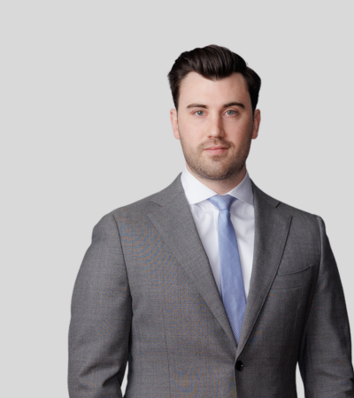 Michael W. McCutcheon bioimage: Studio portrait of a man in gray suit with blue tie