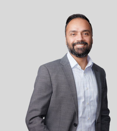 Manpreet Kharod: Studio portrait of a man in gray blazer and shirt