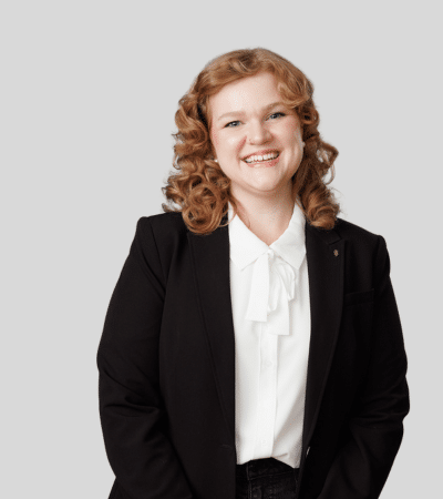 Aubrie L. Kent bioimage: Studio portrait of a woman with curly hair smiling