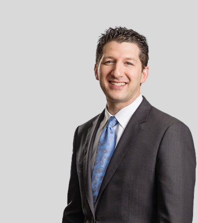 Matthew L. Mustokoff image Man in dark suit with blue tie, smiling.