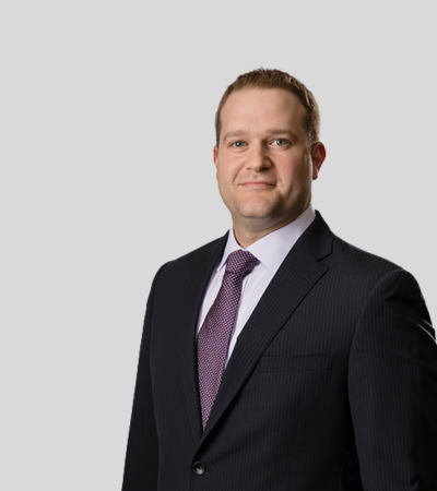 Richard A. Russo, Jr. Bioimage Man in dark suit with purple tie, neutral expression.