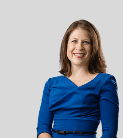 Michelle M. Newcomer bioimage: Studio portrait of a woman in blue dress smiling