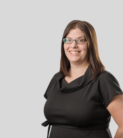 Jennifer L. Enck Bioimage Woman with glasses in black top, smiling.