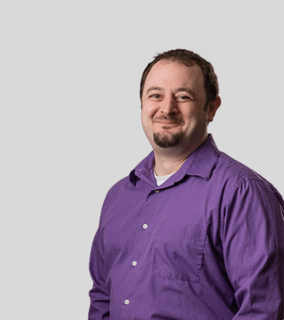 Keith S. Greenwald: Studio portrait of a man wearing purple shirt