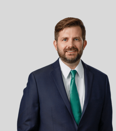 Patrick J. Eddis: Studio portrait of a man in suit with green tie
