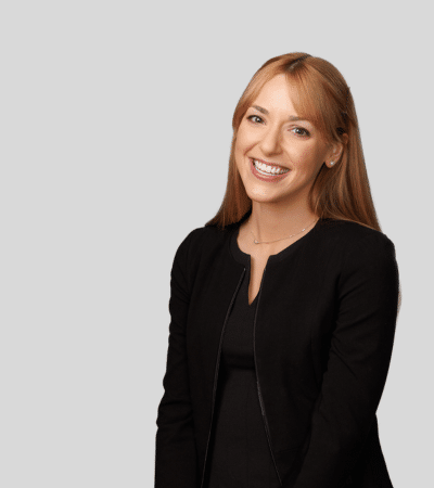 Lauren C. Lummus bioimage: Studio portrait of a woman smiling in black top