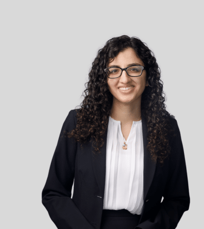 Vanessa M. Milan bioimage: Studio portrait of a woman with curly hair wearing blazer