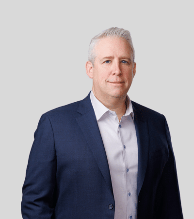 Sean M. Handler image Man with short gray hair in navy blazer, neutral expression.