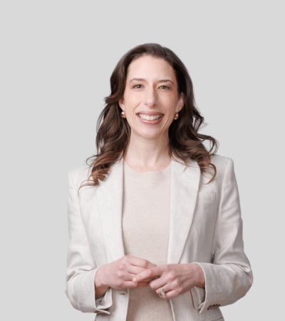 Cassandra Kullman: Studio portrait of a woman in light blazer smiling
