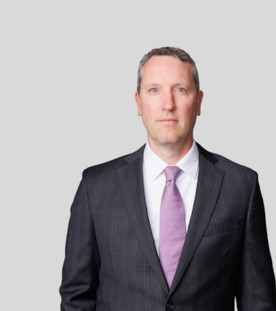 Joshua E. D'Ancona image Man in dark suit with pink tie, neutral expression.