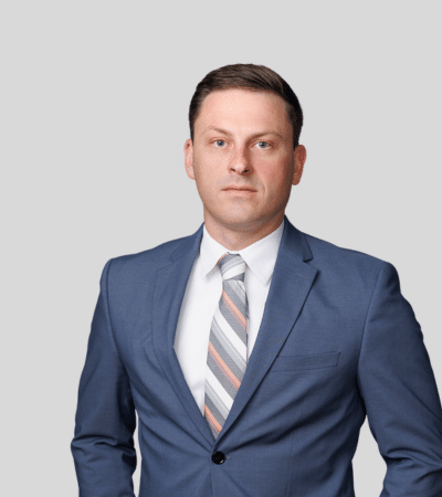 Ryan A. Shelton-Benson: Studio portrait of a man in gray suit with striped tie