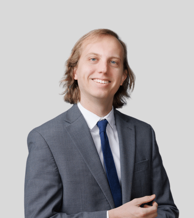 Bryce H. Bennett, III bioimage: Studio portrait of a man with long hair wearing a suit