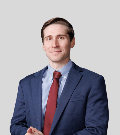 Daniel Dicce bioimage: Studio portrait of a man in blue suit and red tie