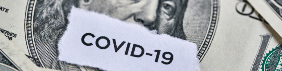US dollar bills with “COVID-19” text partially visible