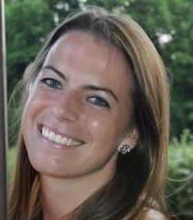 Johanna M. Conicello Woman outdoors with long light brown hair, smiling.