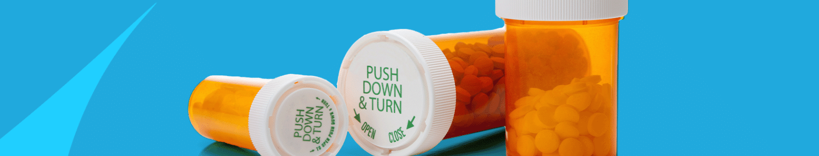 Prescription pill bottles on bright blue background
