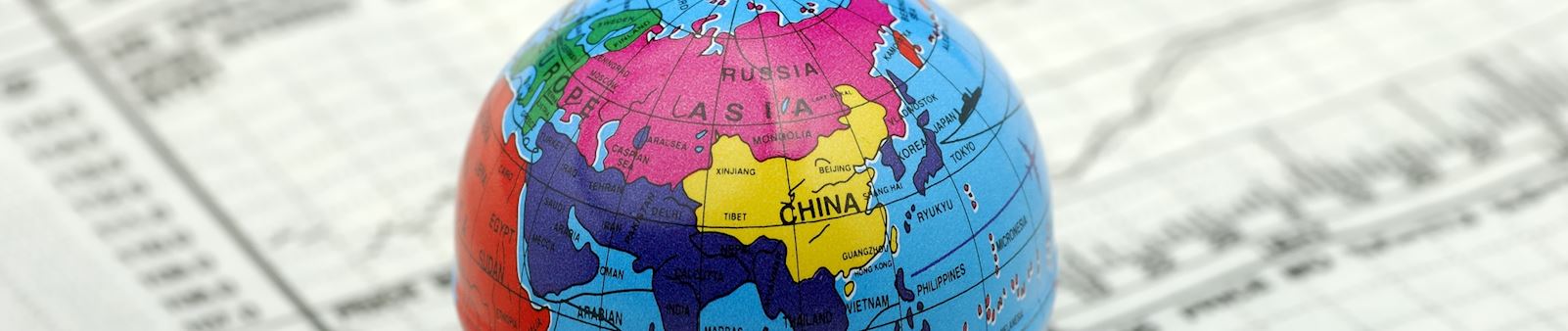 Globe placed on top of US currency representing global finance