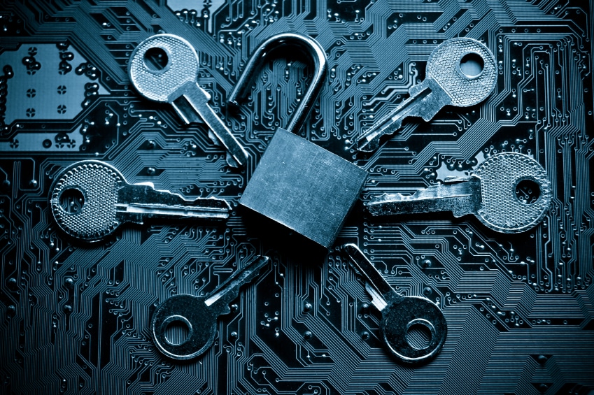 Open padlock surrounded by five keys on a blue circuit board